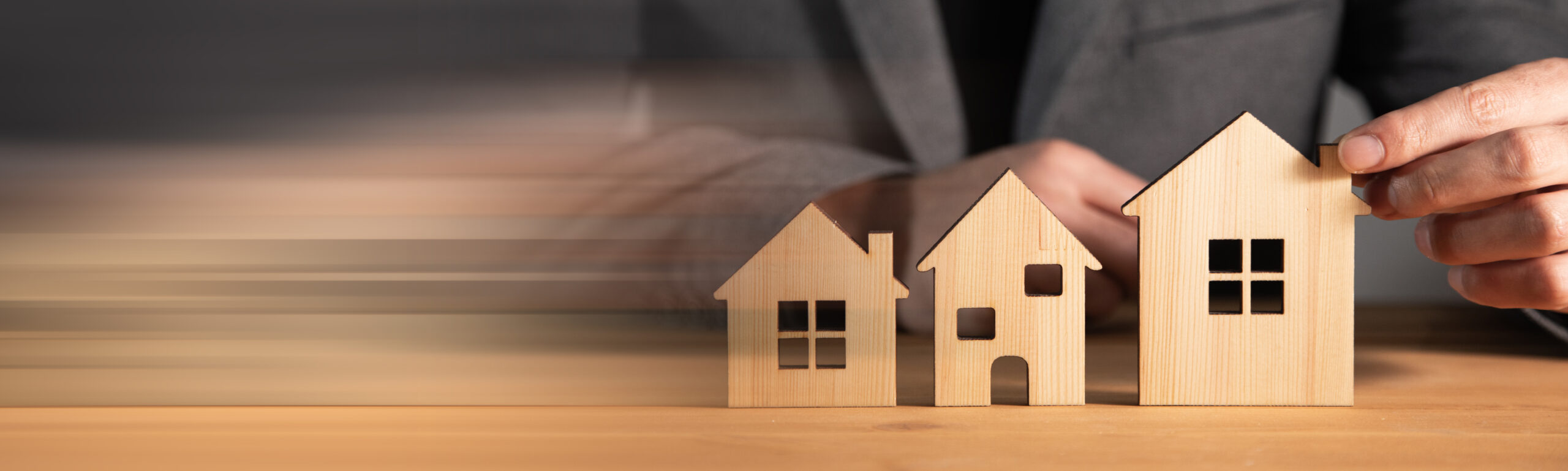 business man holding different house models