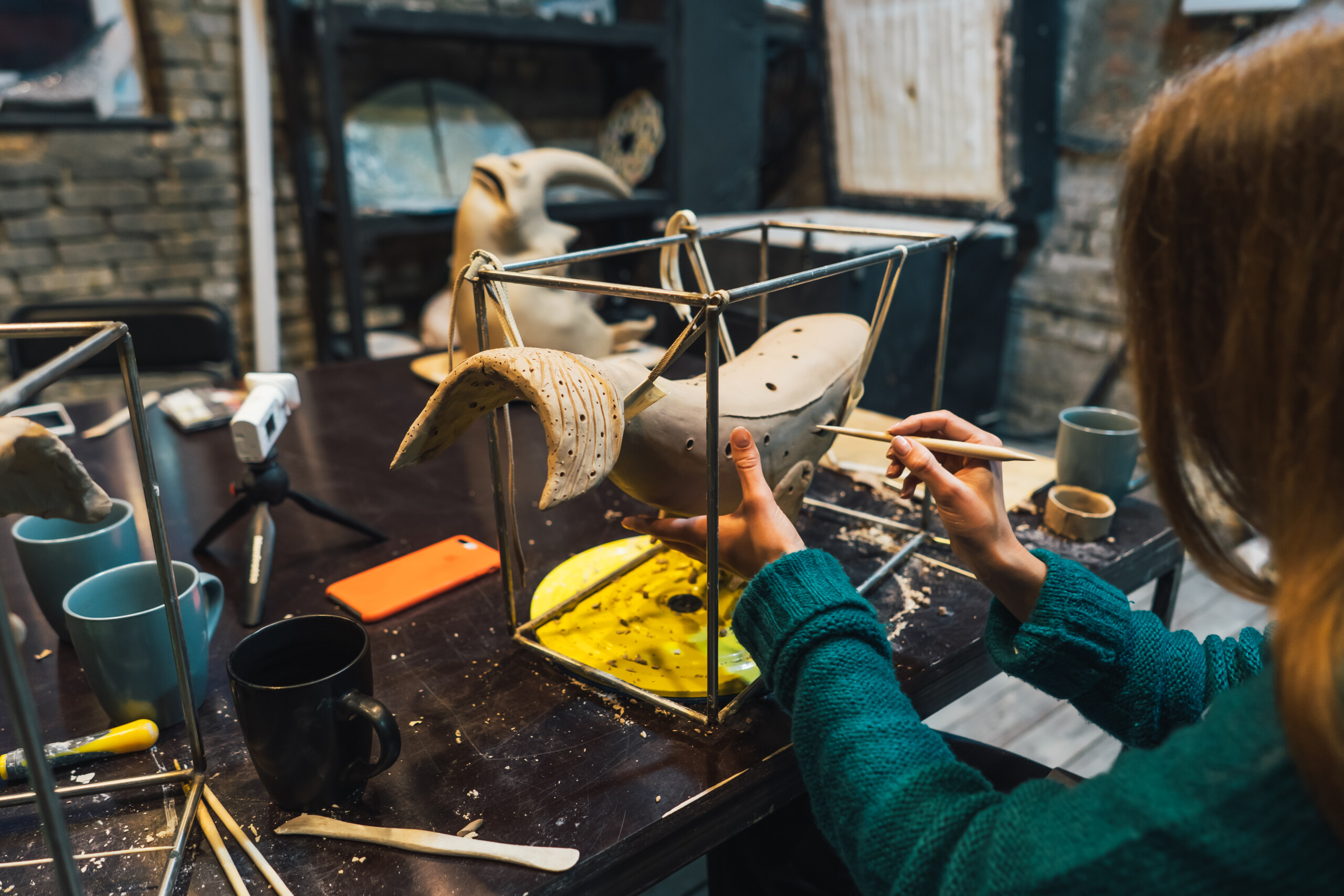 Portrait of young woman enjoying favorite job in workshop.